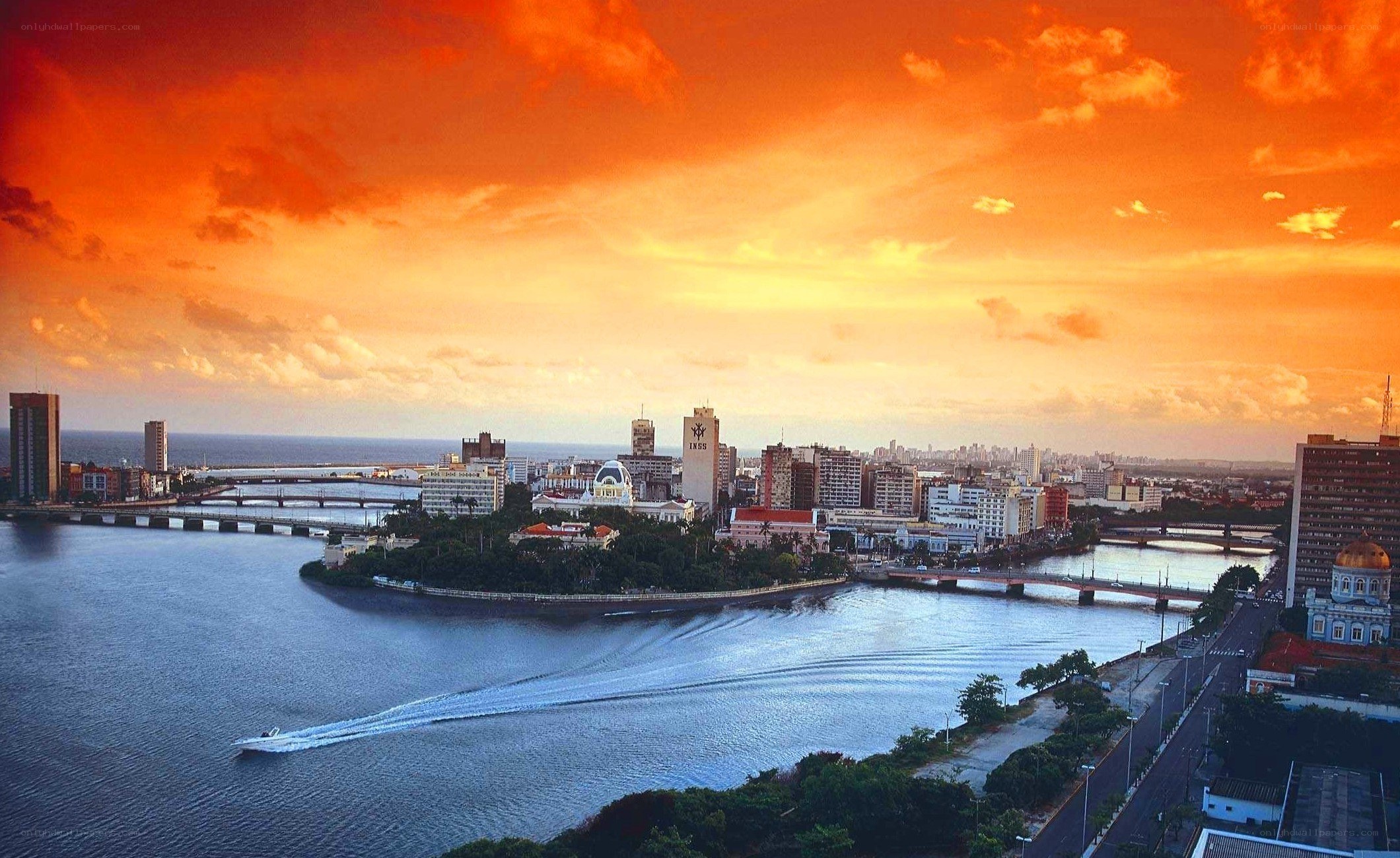 sunset over city by the water