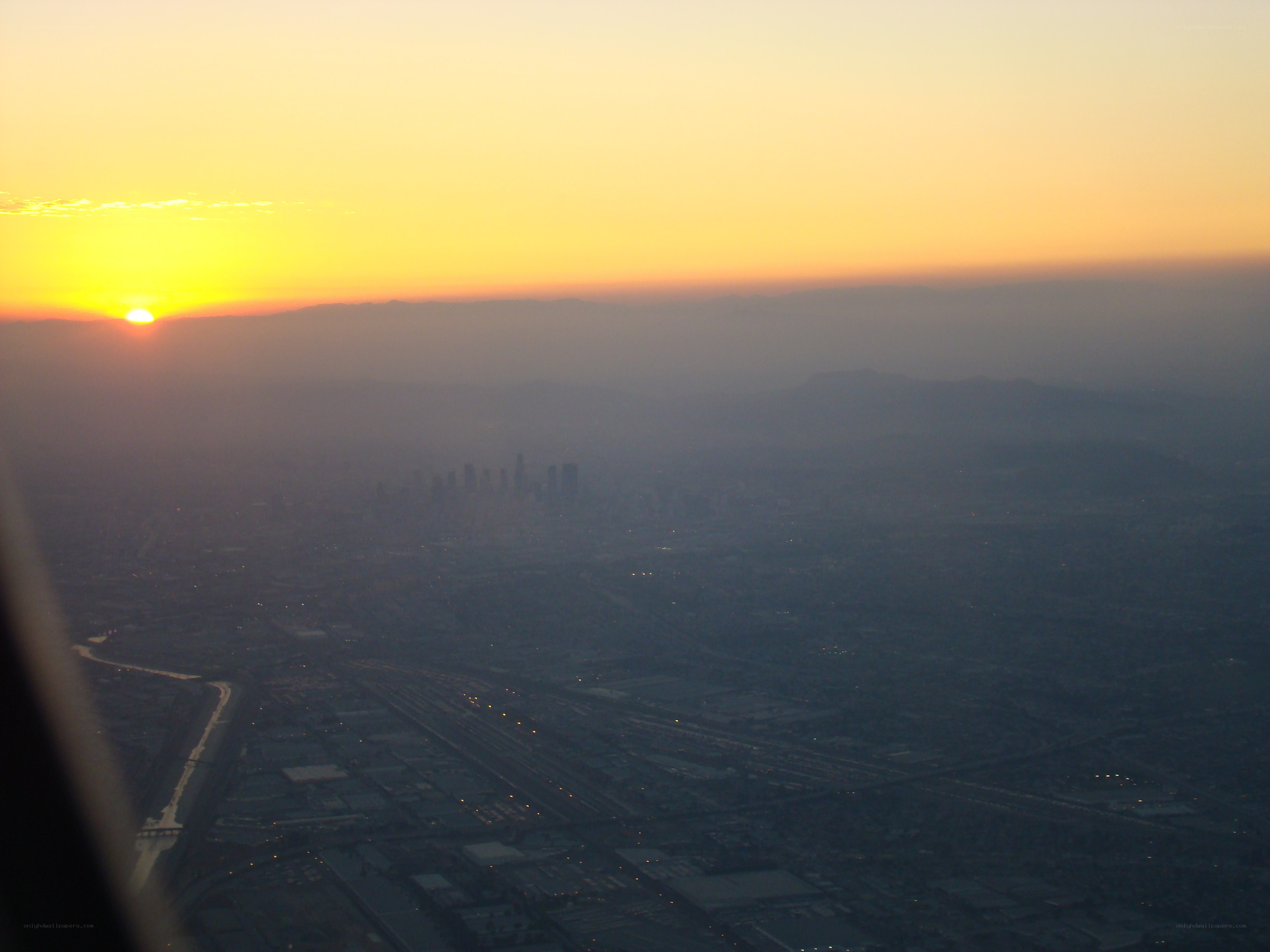 sunset over city from airplane