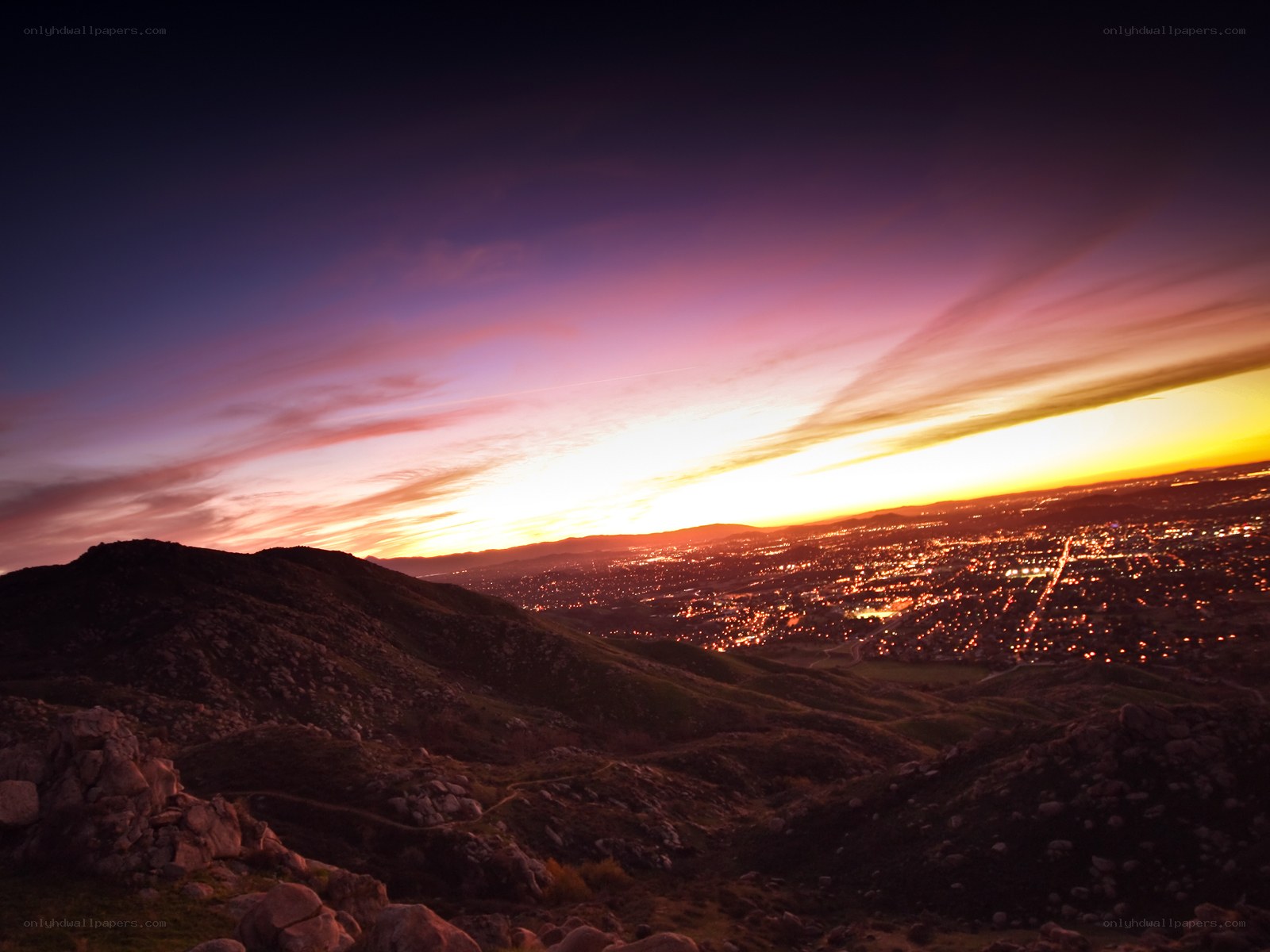 sunset over city from hilltop