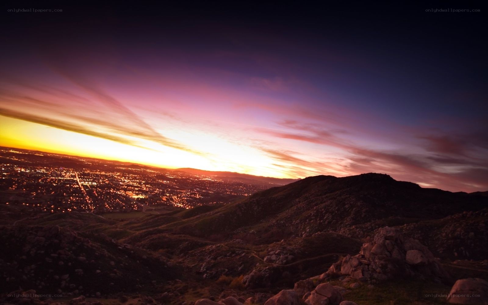 sunset over city from hilltop