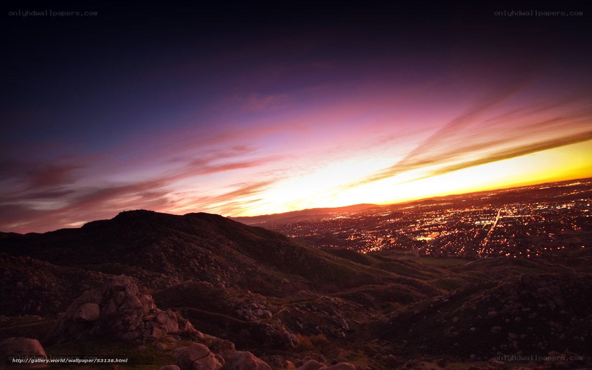 Sunset over city from hilltop