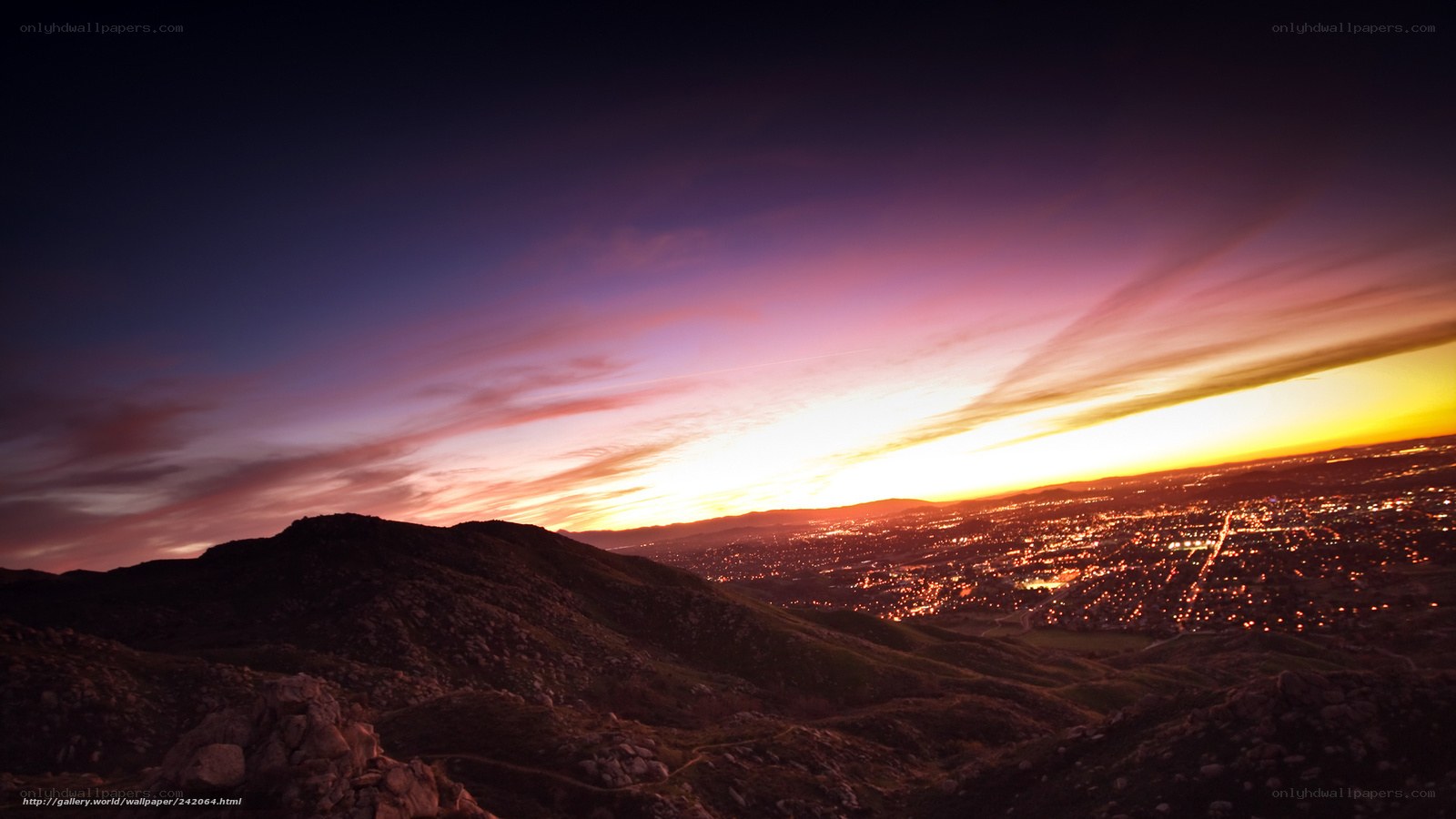 sunset over city from mountain