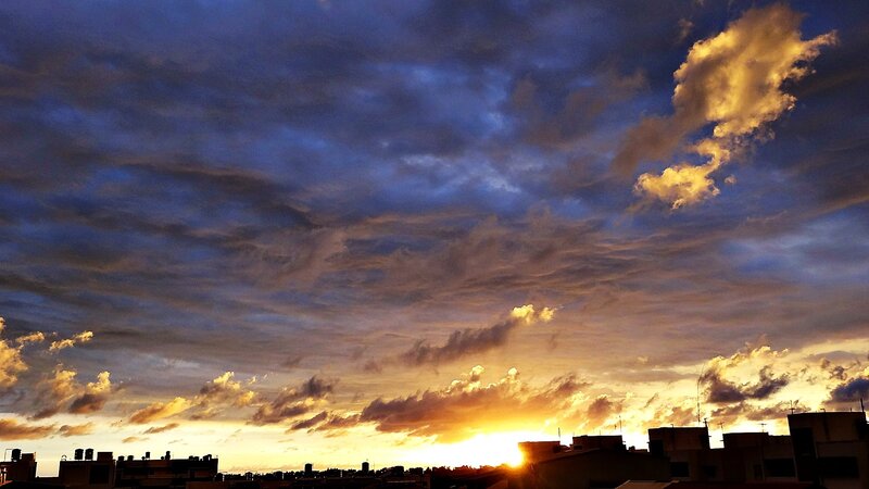 Sunset over city rooftops