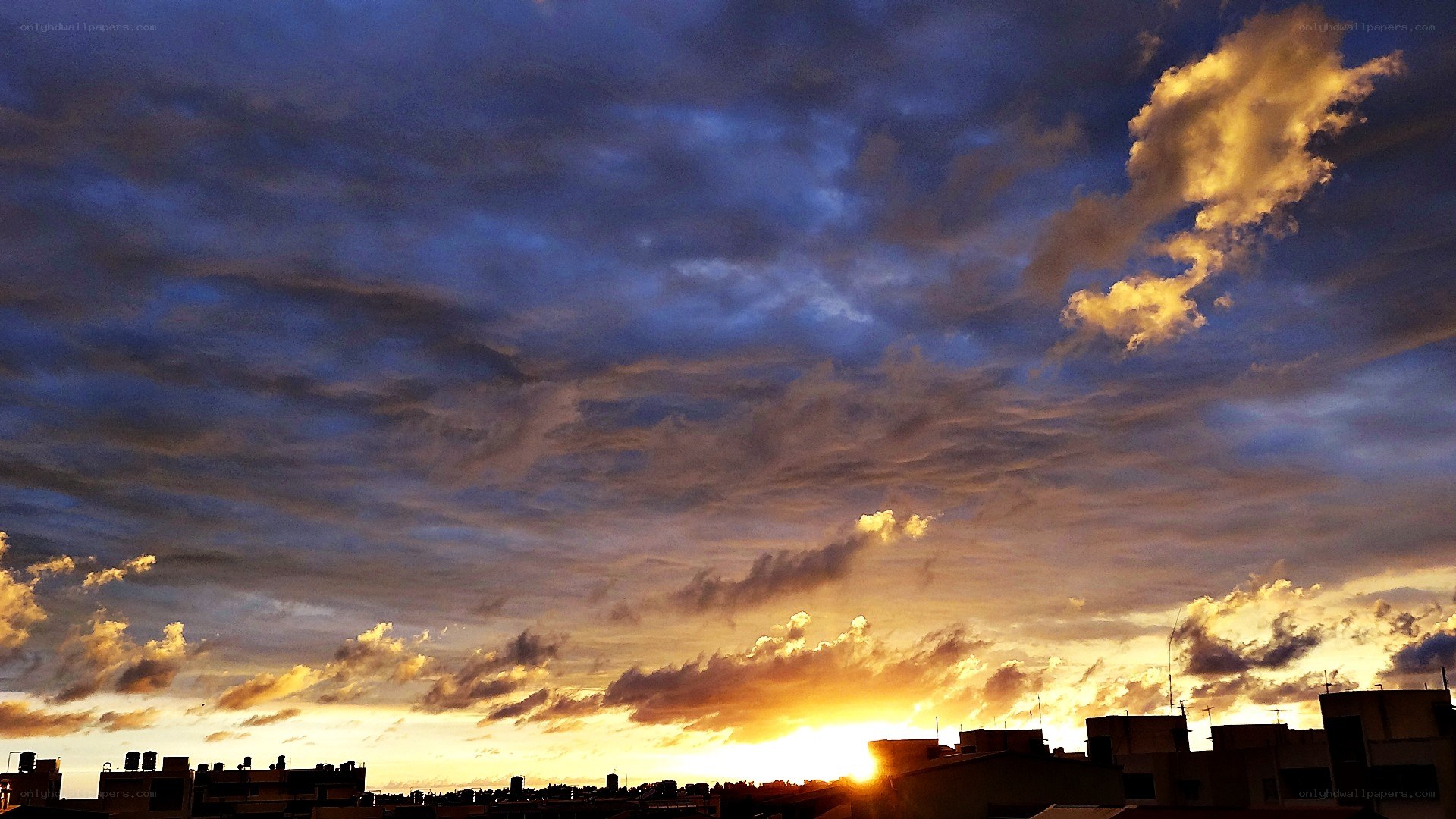 Sunset over city rooftops
