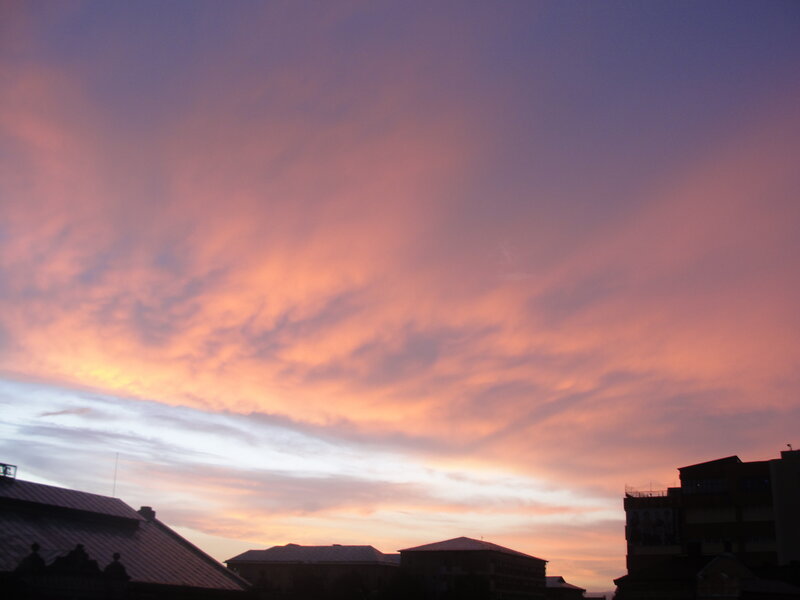 Sunset over city rooftops