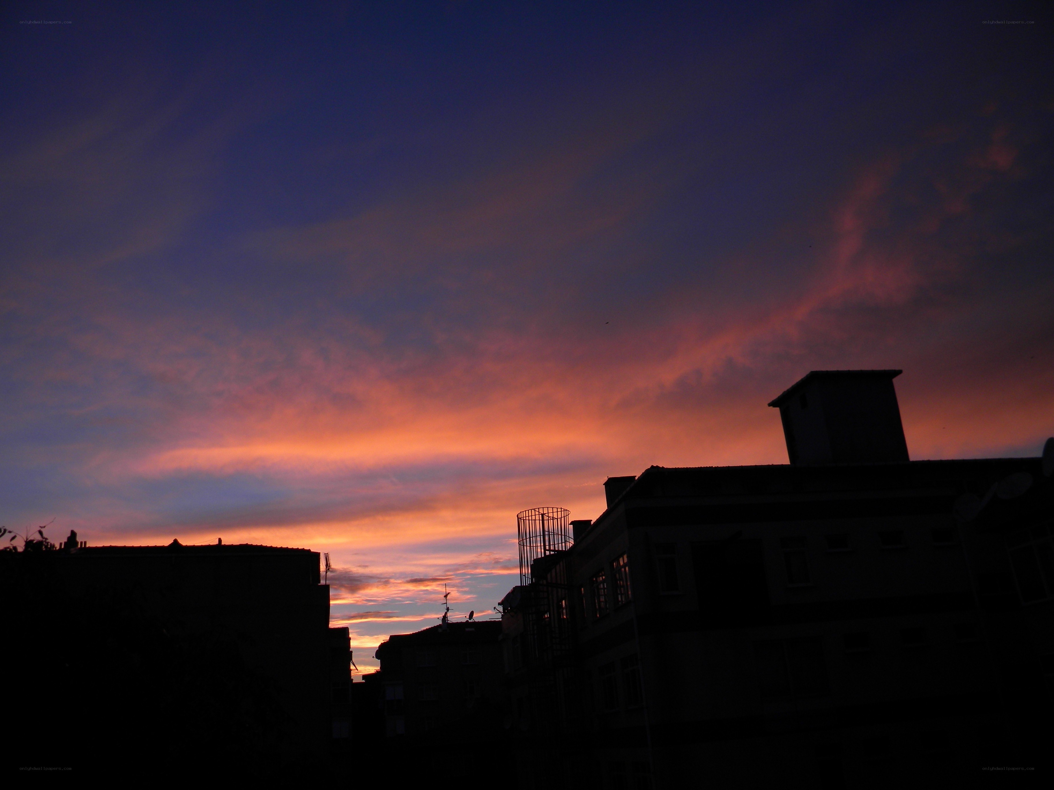 sunset over city rooftops
