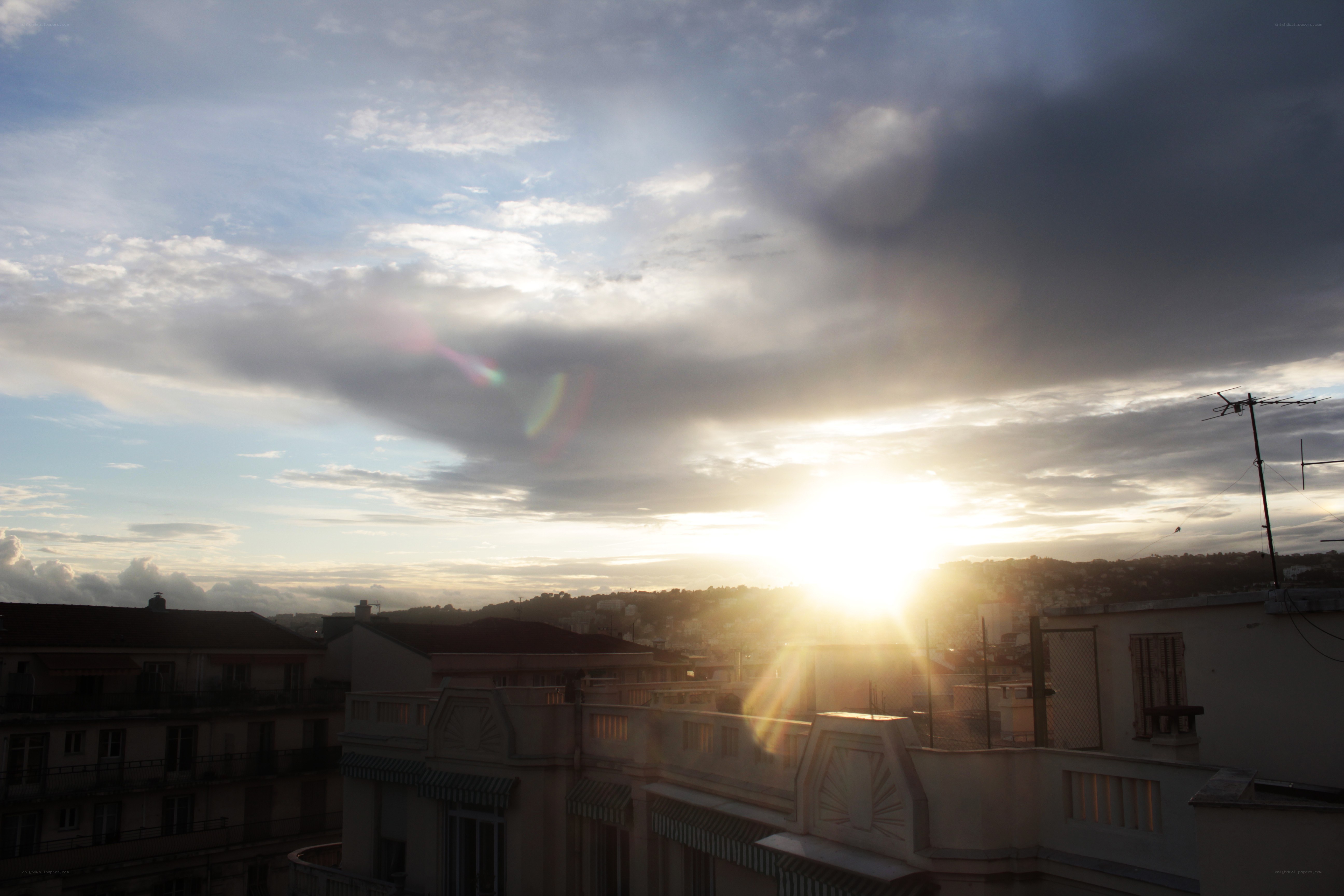 Sunset over city rooftops