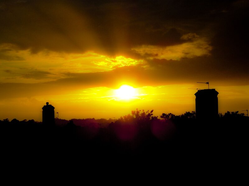Sunset over city rooftops