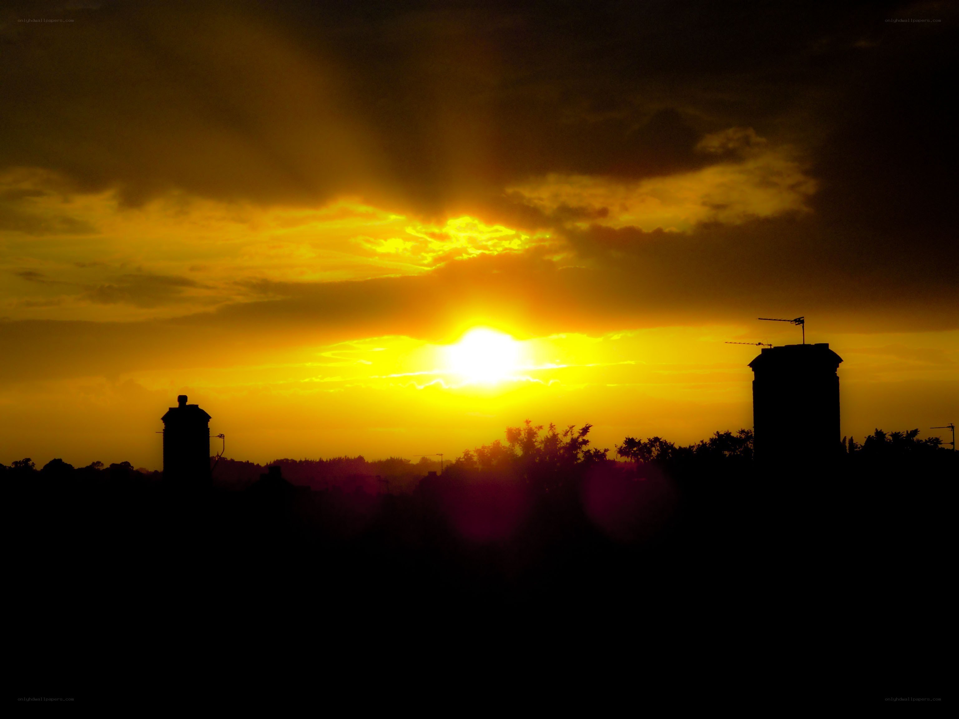 Sunset over city rooftops