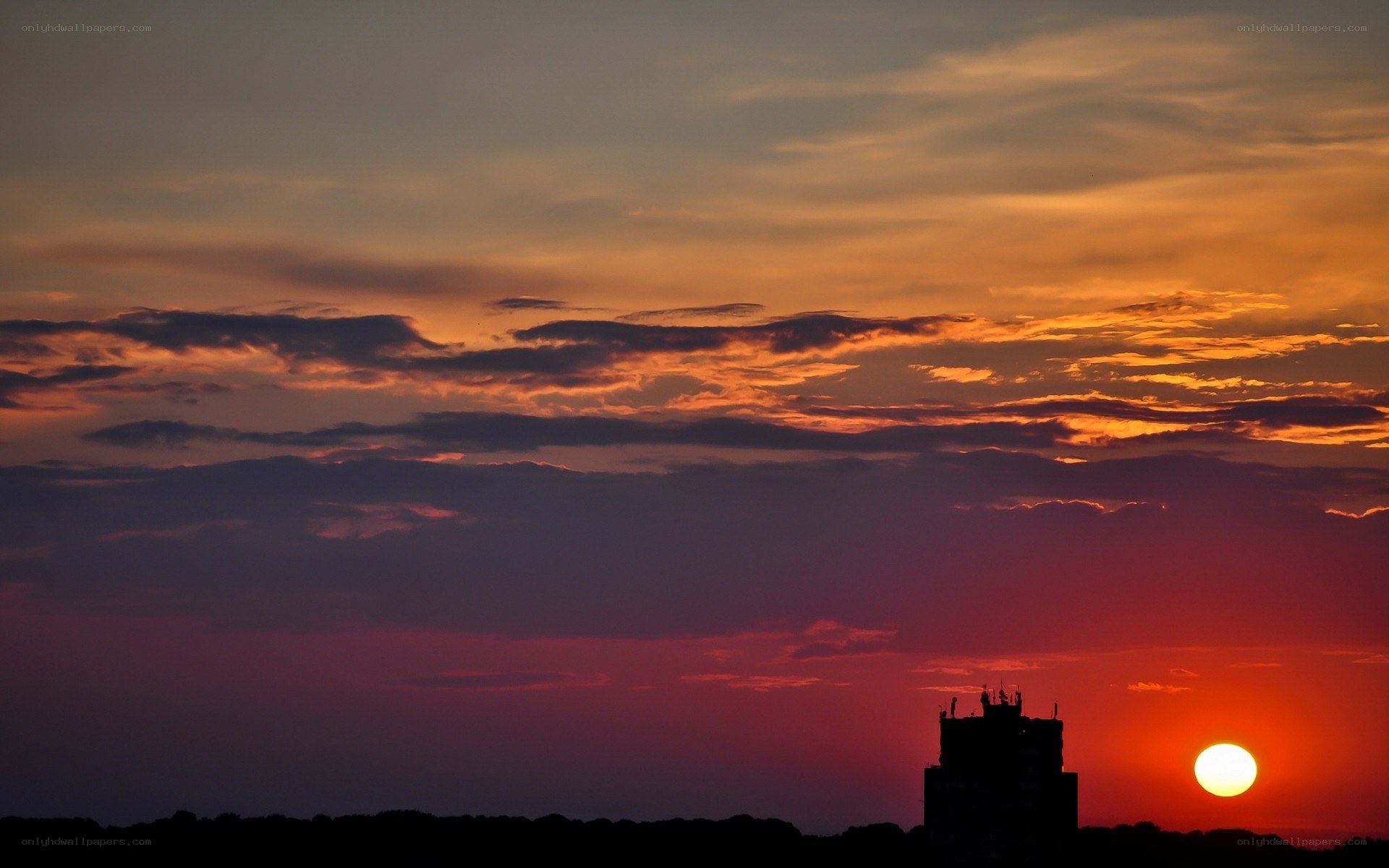 Sunset over city silhouette