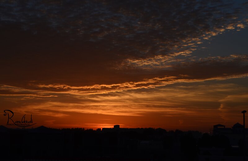 Sunset over City Skyline — Orange, Dramatic, Photograph, Clouds, Buildings, Sky