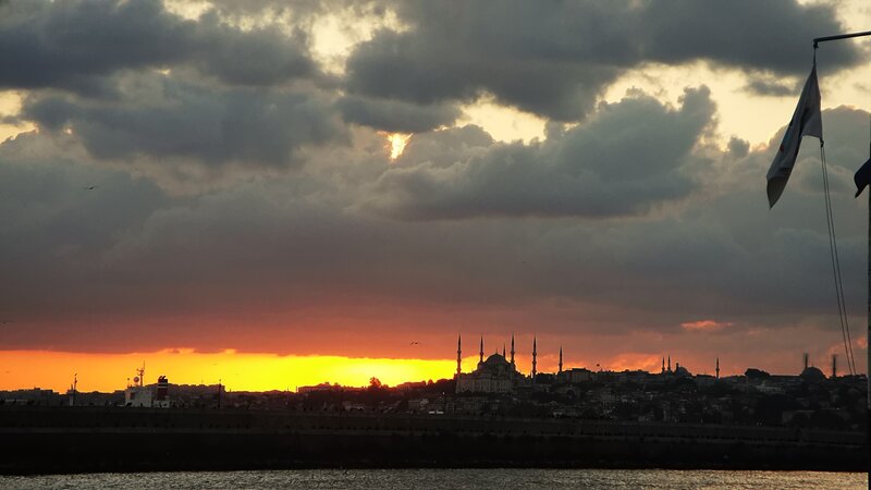 Sunset over City Skyline — Orange, Dramatic, Photograph, Clouds, Flag