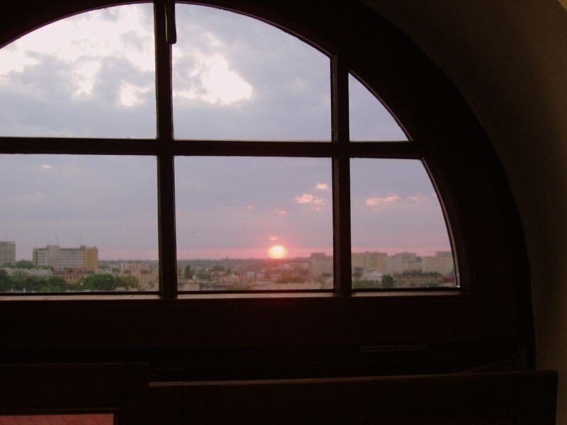 Sunset over city through window