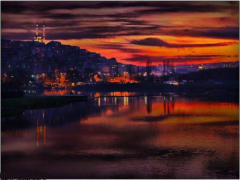 sunset over city with mosque