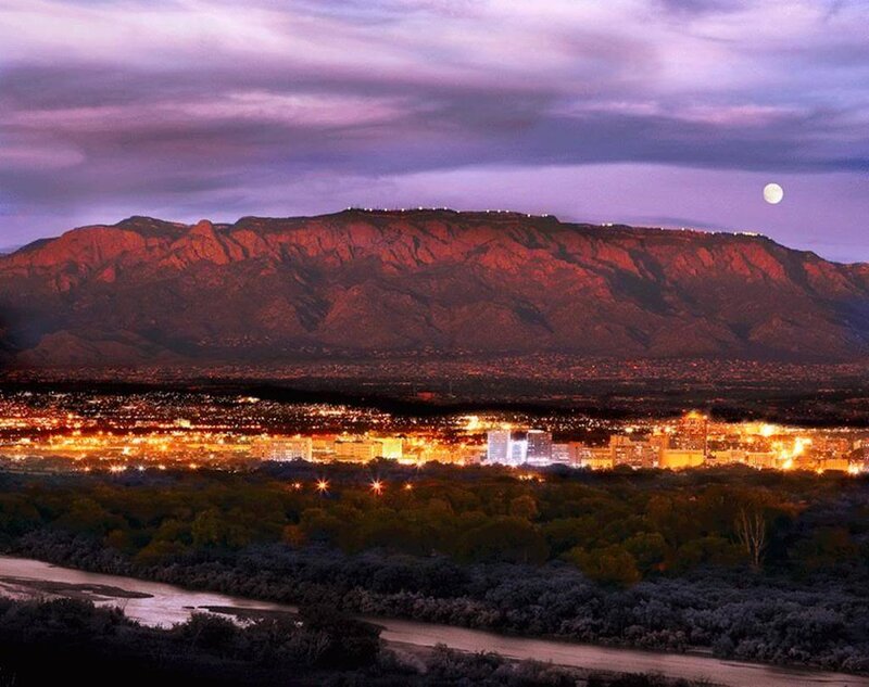 Sunset over city with mountain backdrop