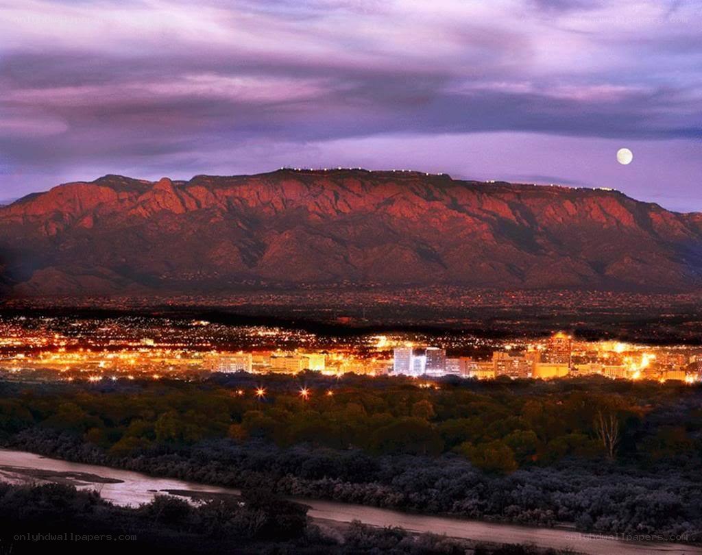 Sunset over city with mountain backdrop