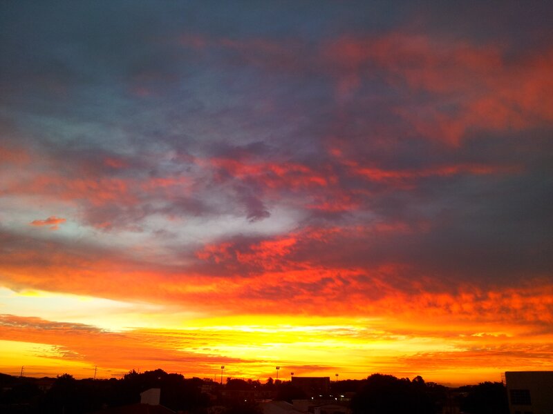 Sunset over Cityscape — Orange, Dramatic, Photograph, Clouds, Buildings