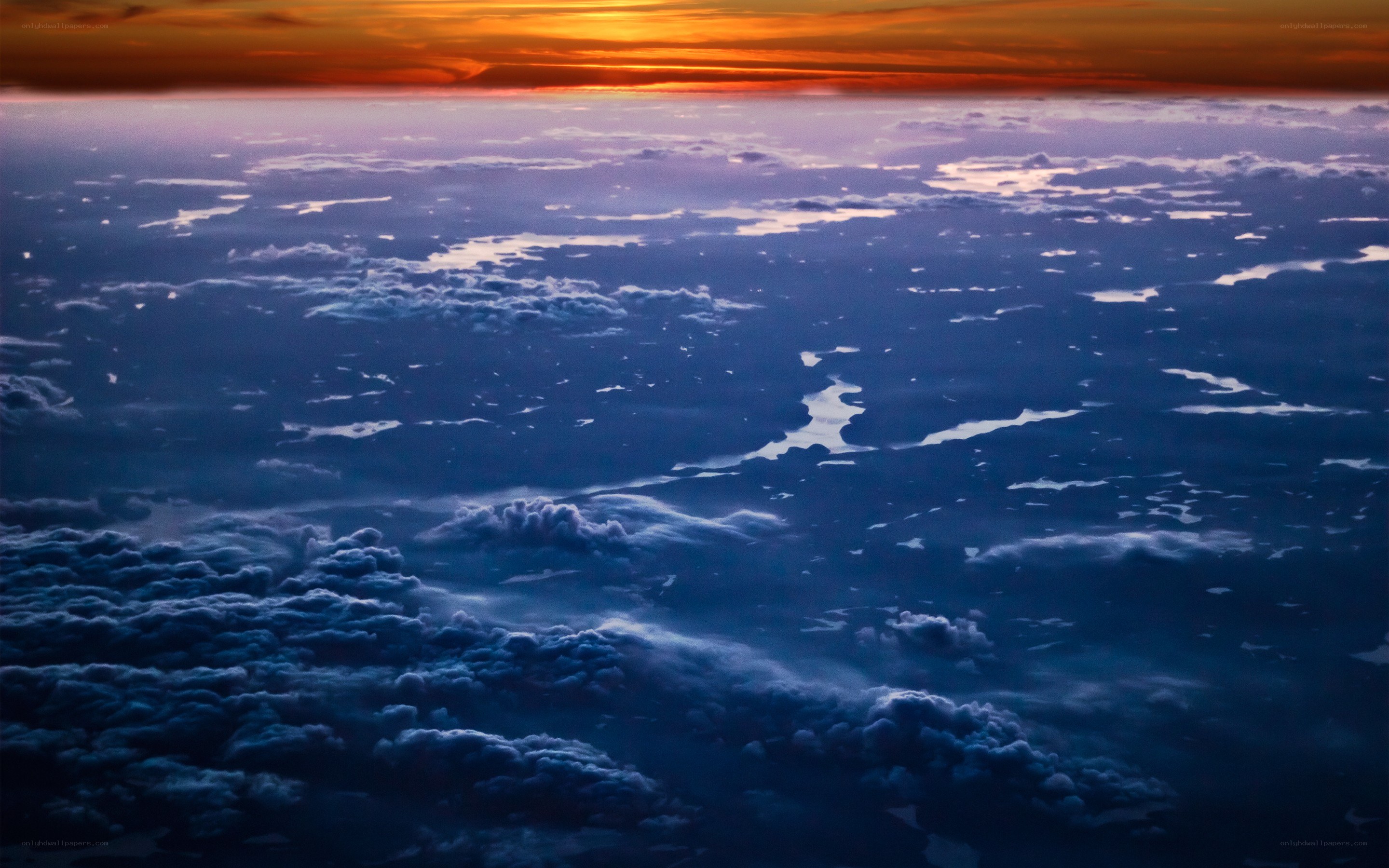 Sunset over clouds from above