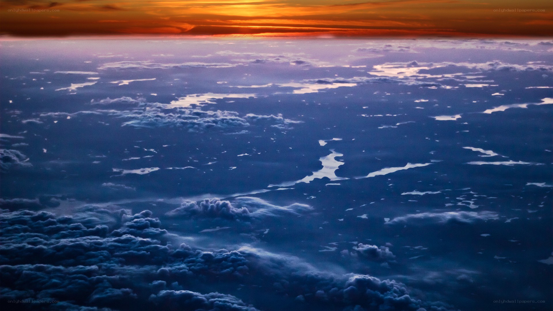 Sunset over clouds from above