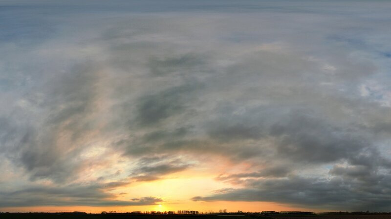 Sunset over cloudy fields