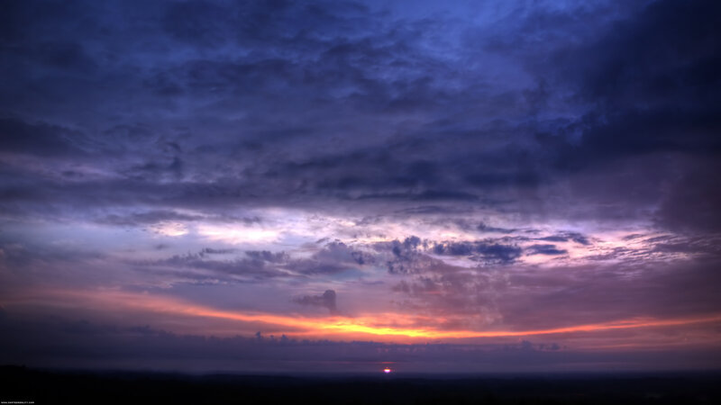 sunset over cloudy sky