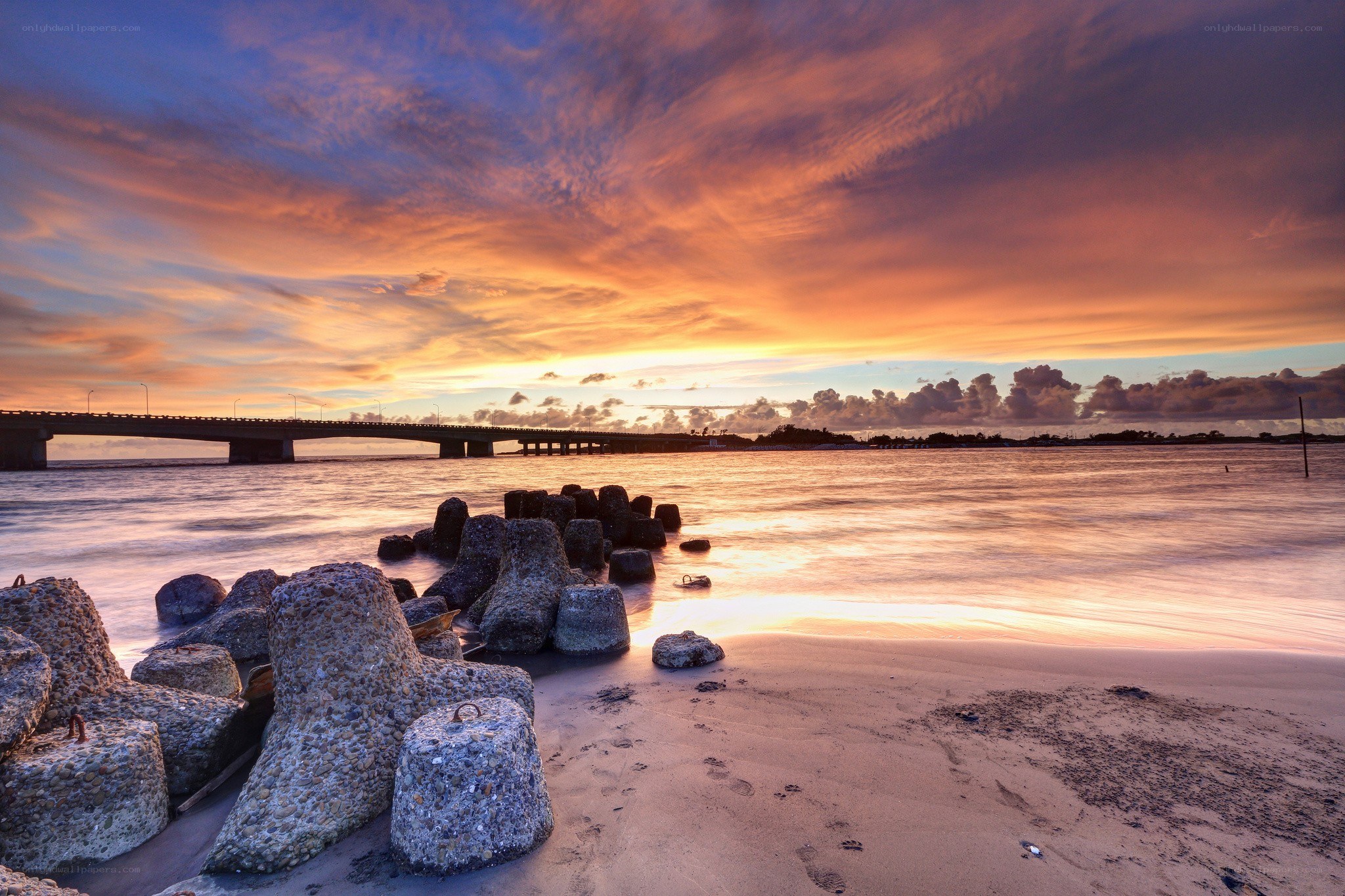 Sunset over coastal bridge