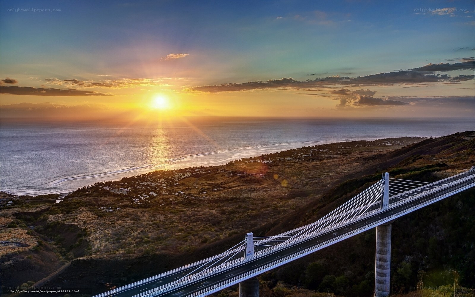 Sunset over coastal bridge