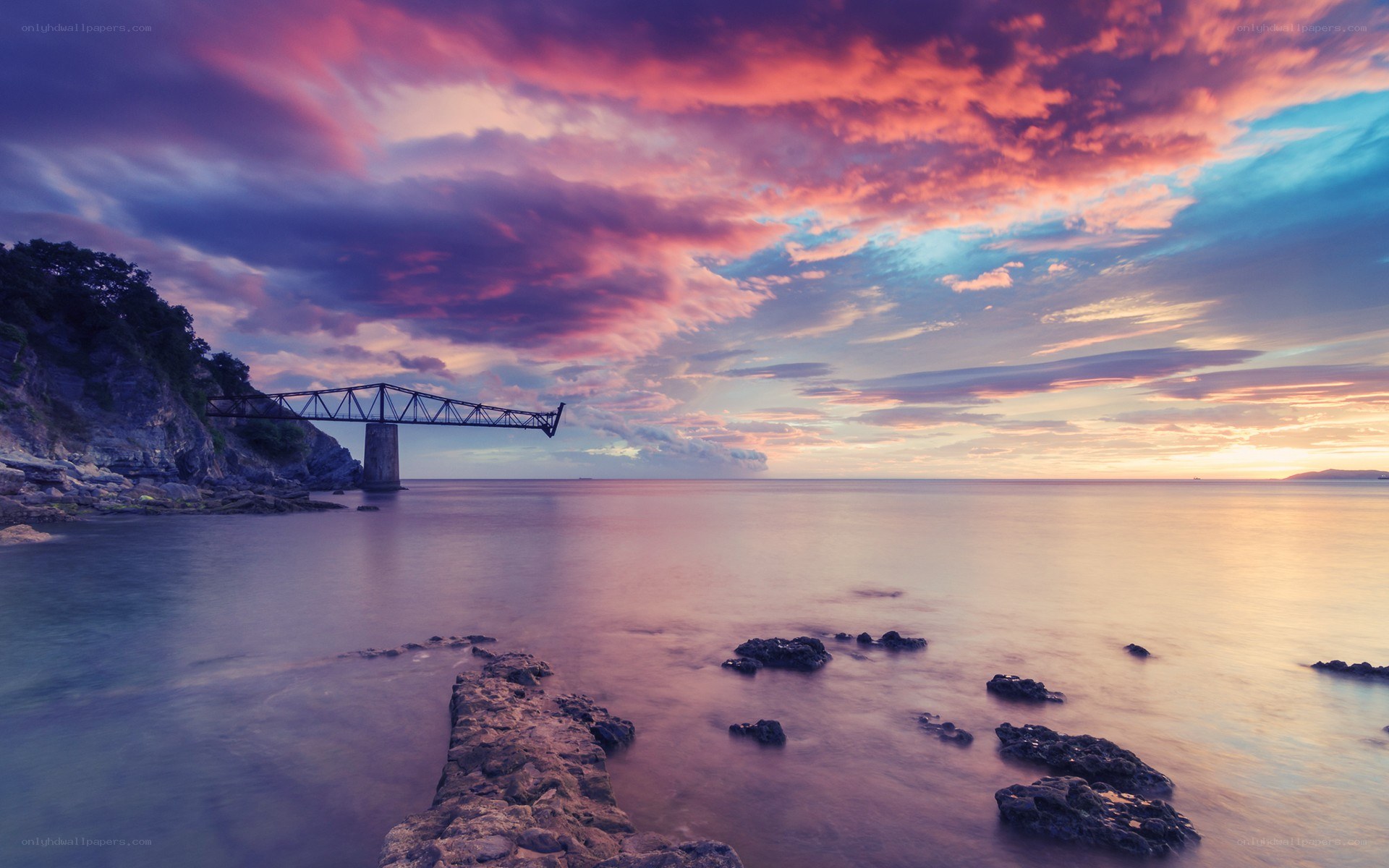 Sunset over coastal bridge