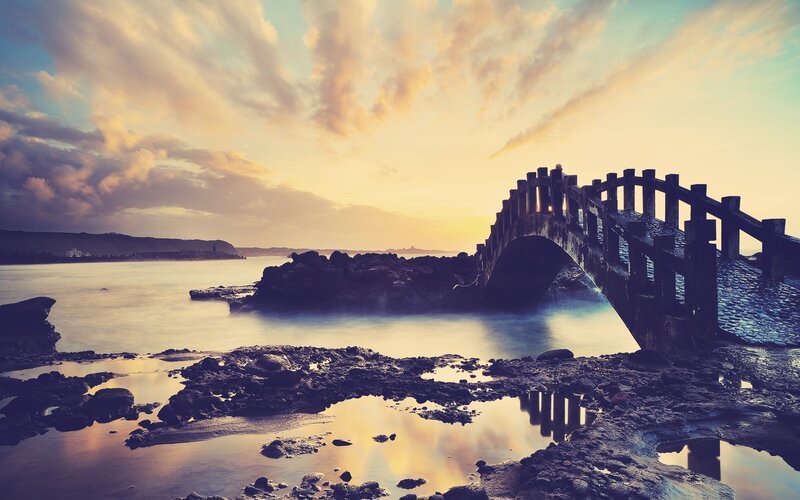 Sunset over coastal bridge