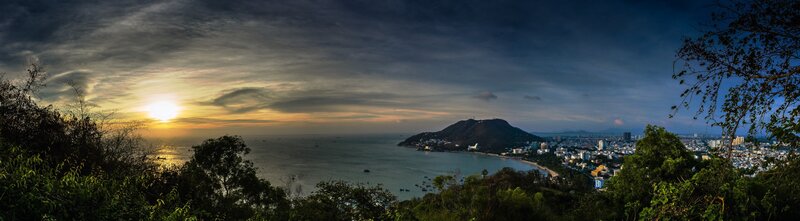Sunset over Coastal City — Blue, Serene, Photograph, Sea, Mountain