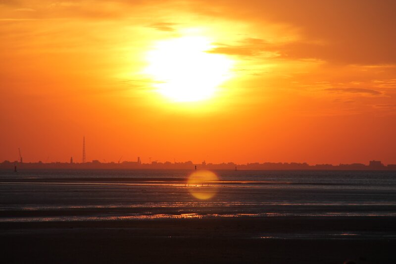 Sunset over Coastal City — Orange, Dramatic, Photograph
