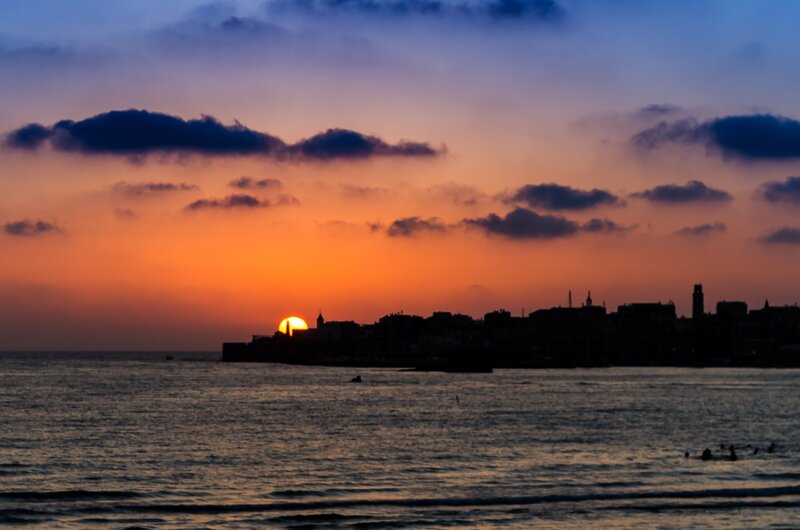 Sunset over Coastal City — Orange, Dramatic
