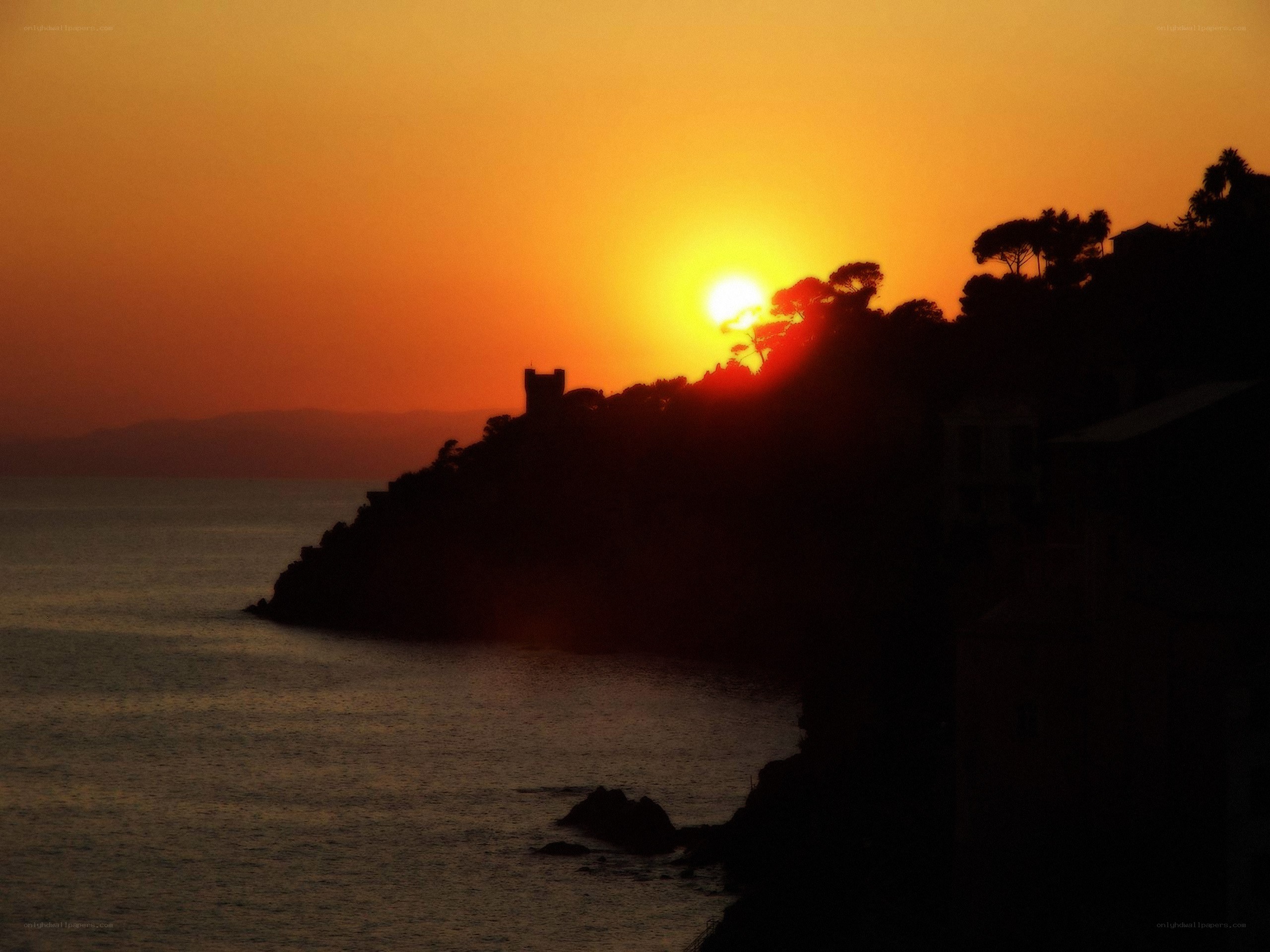 sunset over coastal cliff