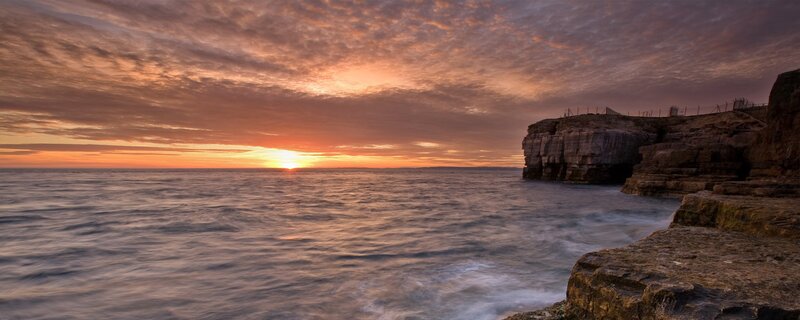 Sunset over coastal cliffs