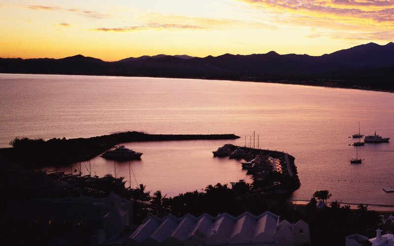 sunset over coastal harbor