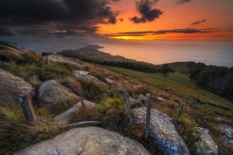 Sunset over Coastal Hills — Orange, Dramatic, Photograph