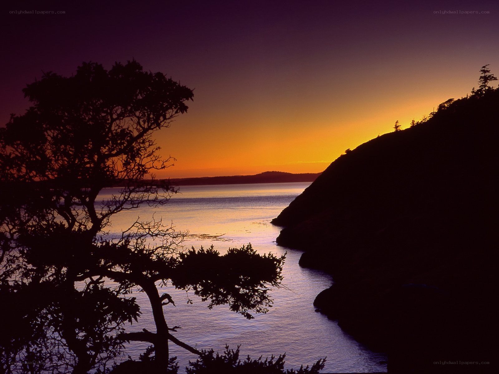 sunset over coastal inlet