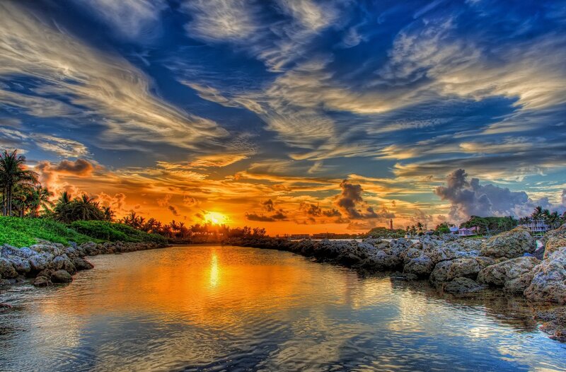 Sunset over Coastal Inlet — Orange, Dramatic, Photograph, Palm Trees, Rocks, Lighthouse, Clouds