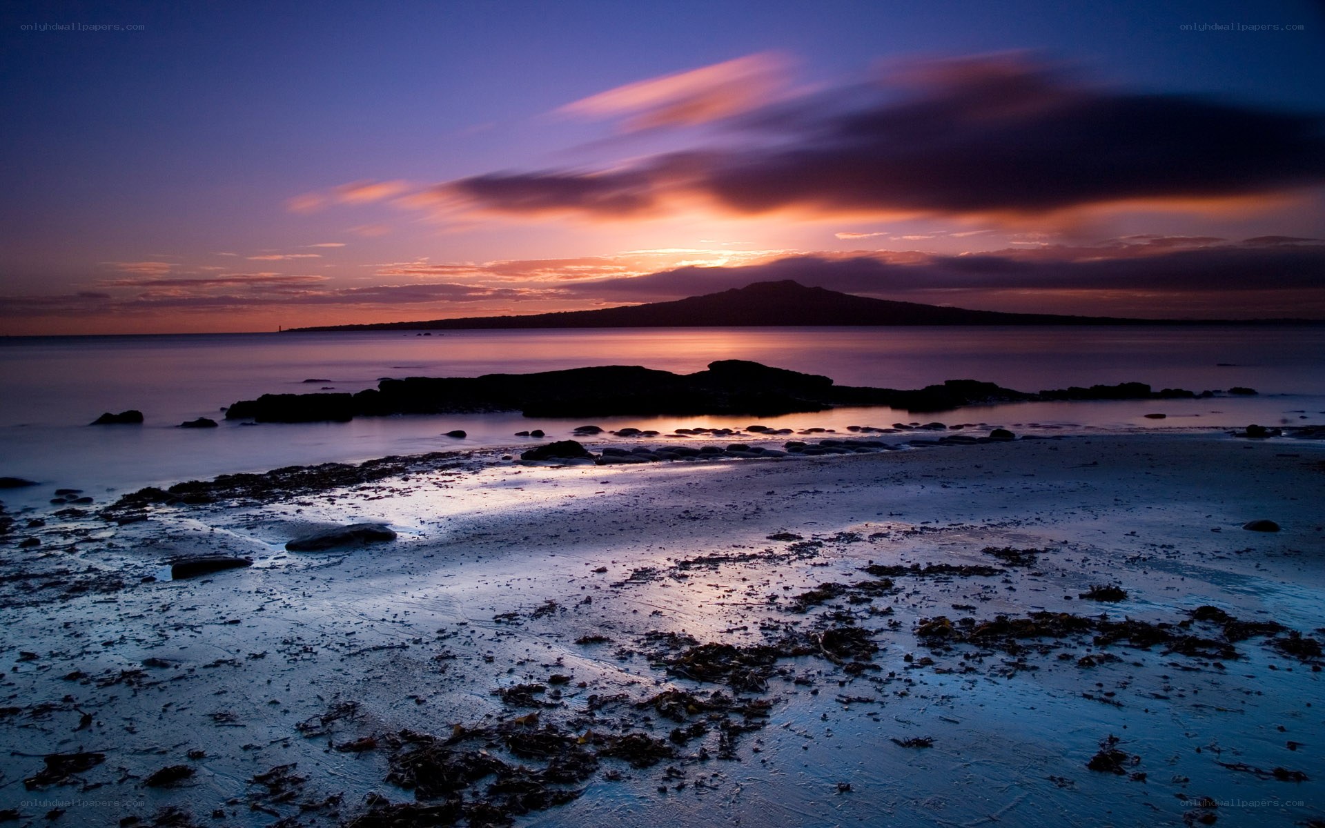 Sunset over coastal landscape