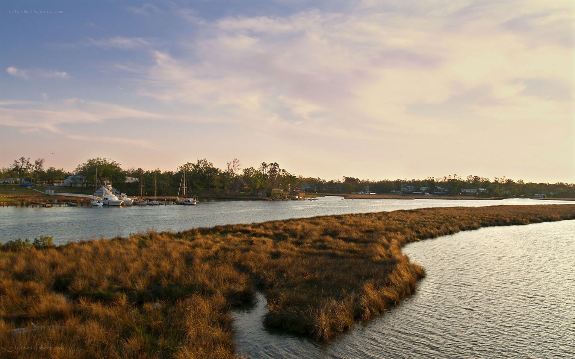 sunset over coastal marsh and marina