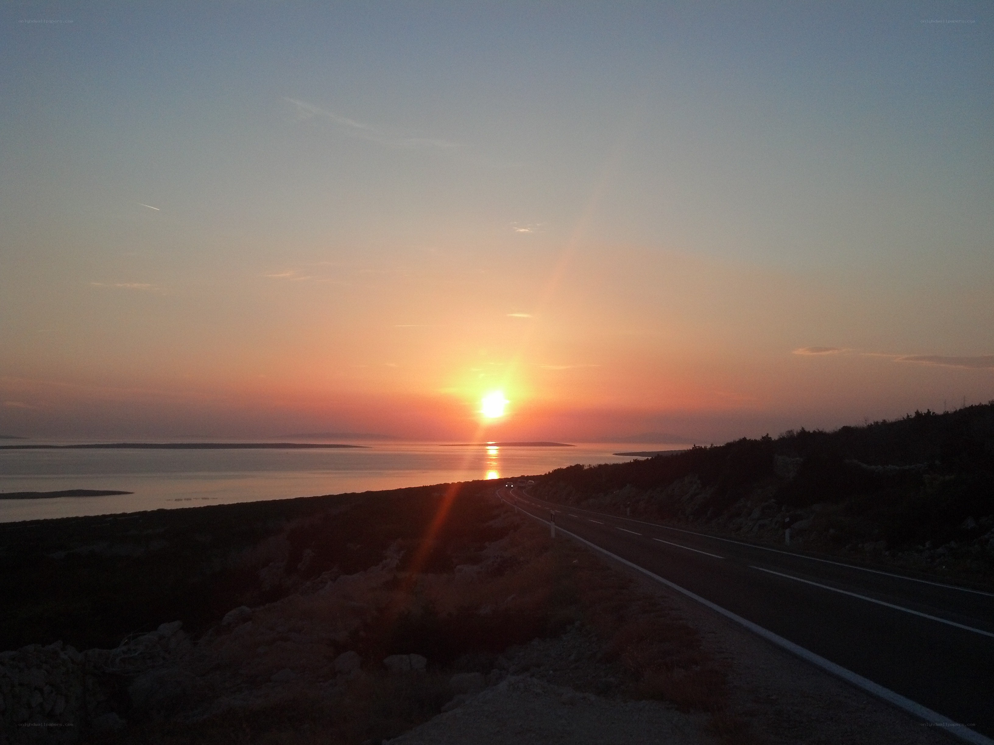 Sunset over coastal road