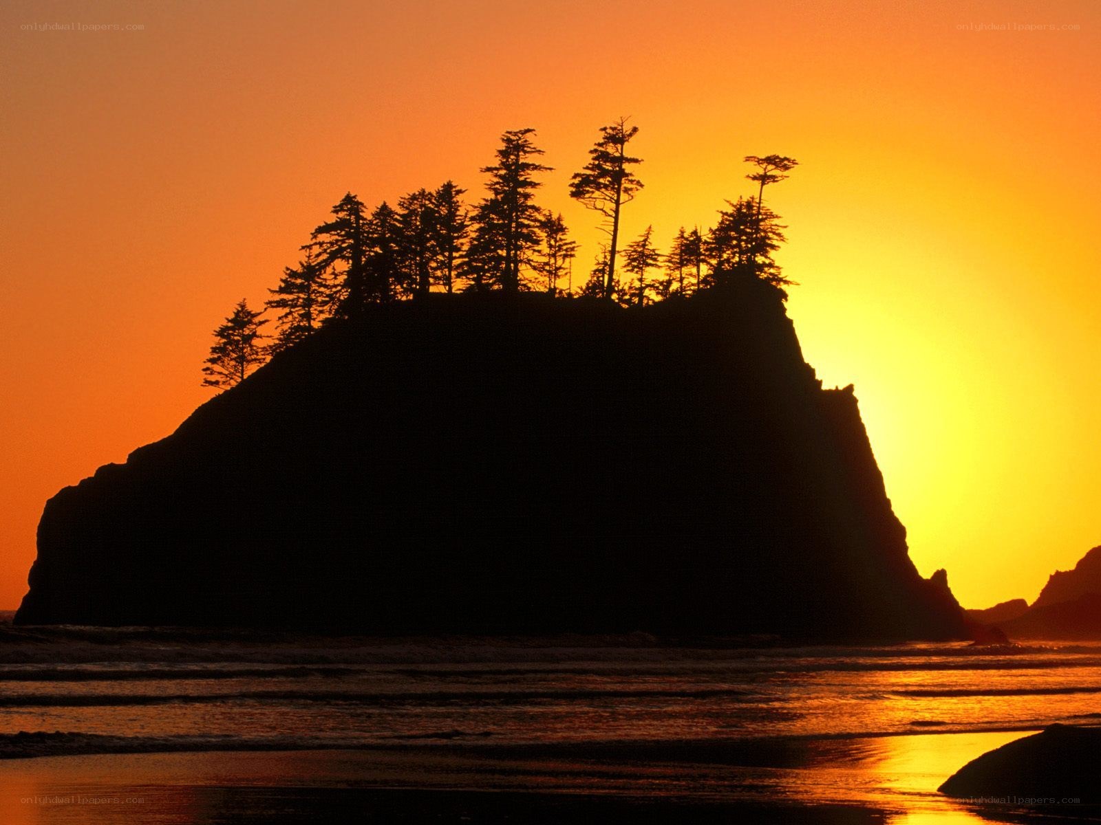 Sunset over coastal rock formation