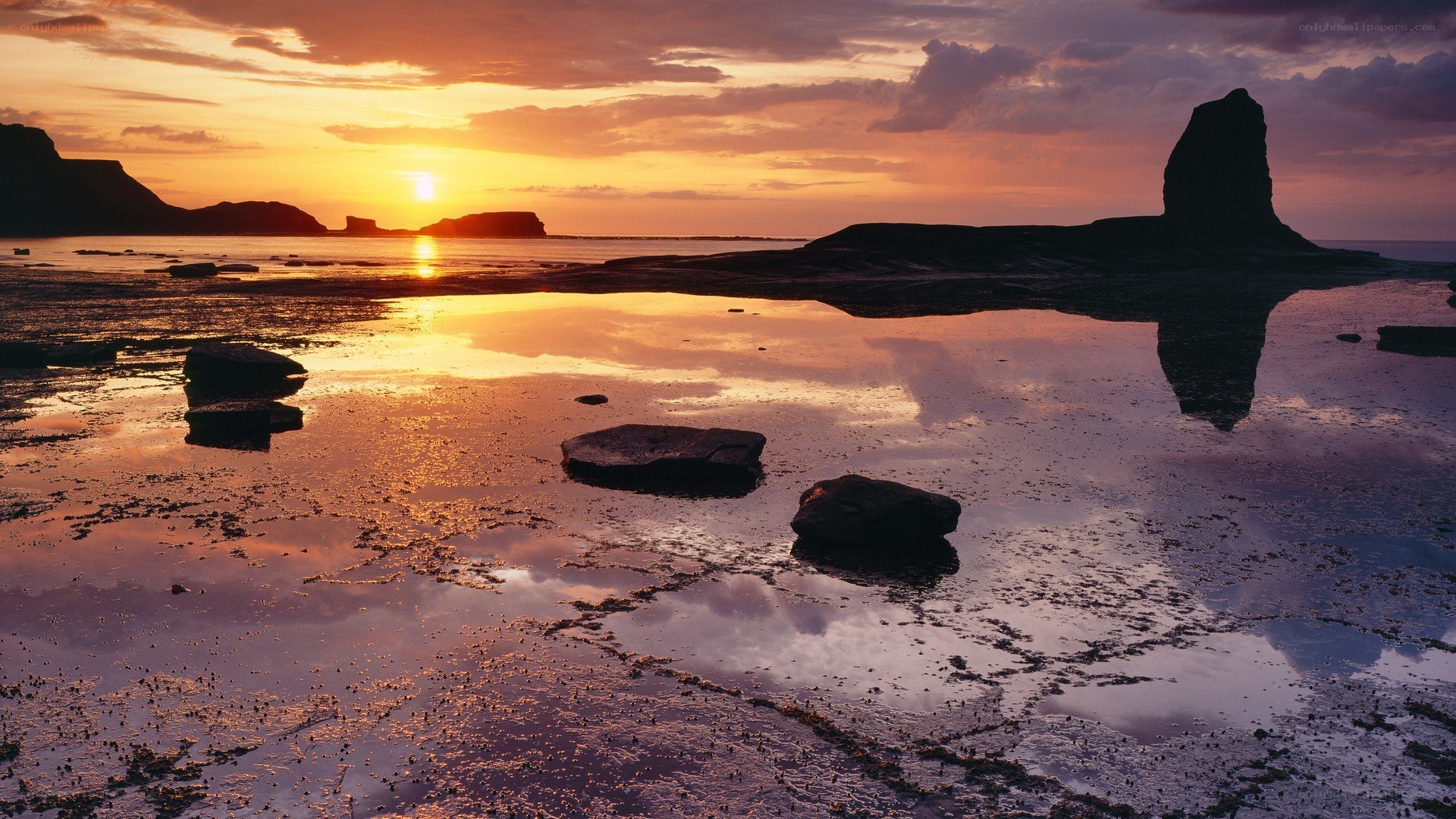 sunset over coastal rocks