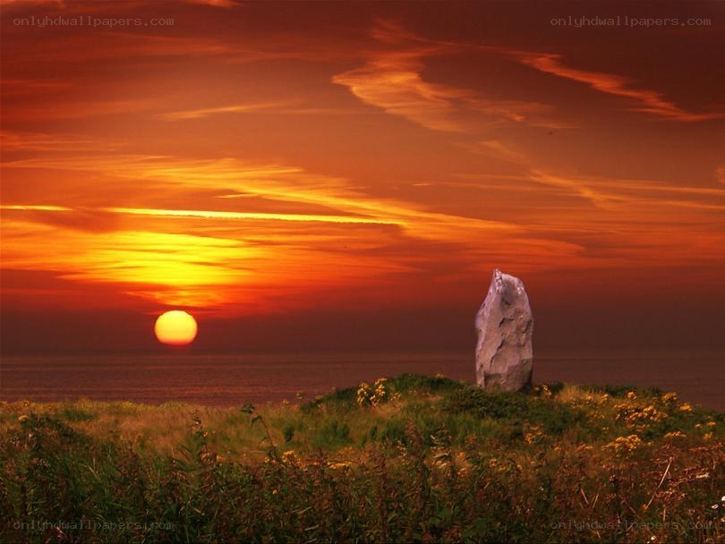 Sunset over coastal stone