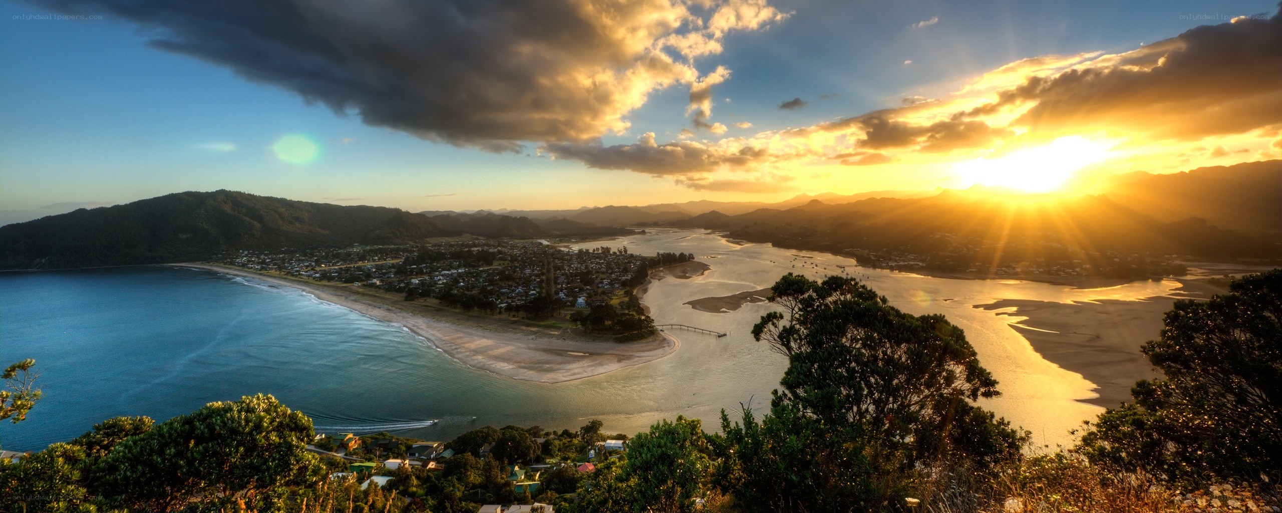Sunset over coastal town and river