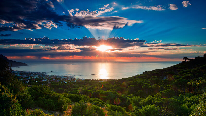 Sunset over Coastal Town — Blue, Dramatic, Photograph, Ocean