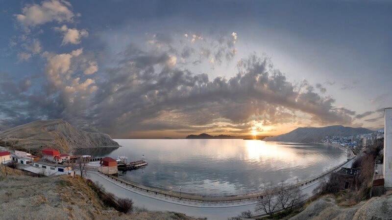 Sunset over Coastal Town — Blue, Dramatic, Photograph, Sea, Mountains
