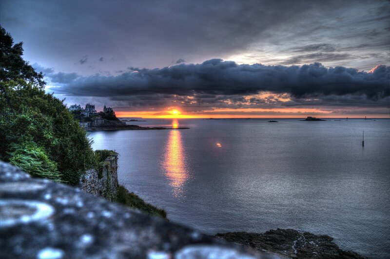 Sunset over Coastal Town — Orange, Dramatic, Photograph, Sea, Clouds