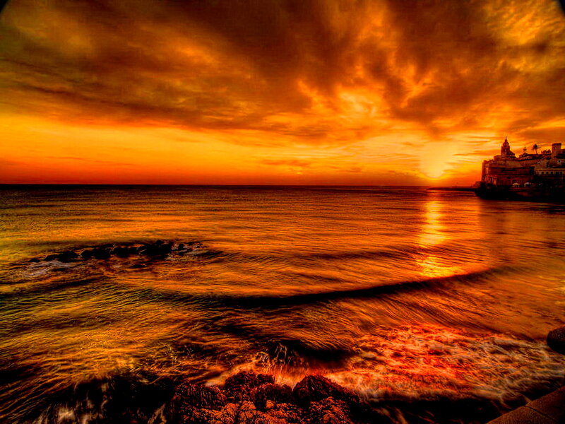 Sunset over Coastal Town — Orange, Dramatic, Photograph