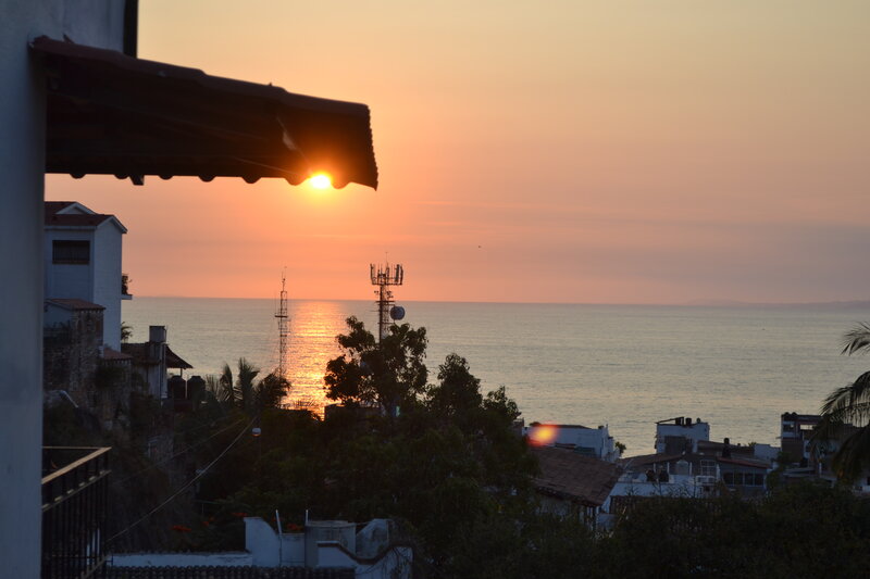 Sunset over Coastal Town — Orange, Serene, Photograph, Ocean